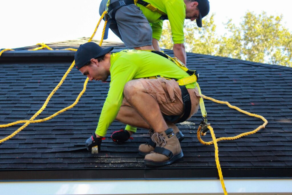 Roofing crew installing new shingles
