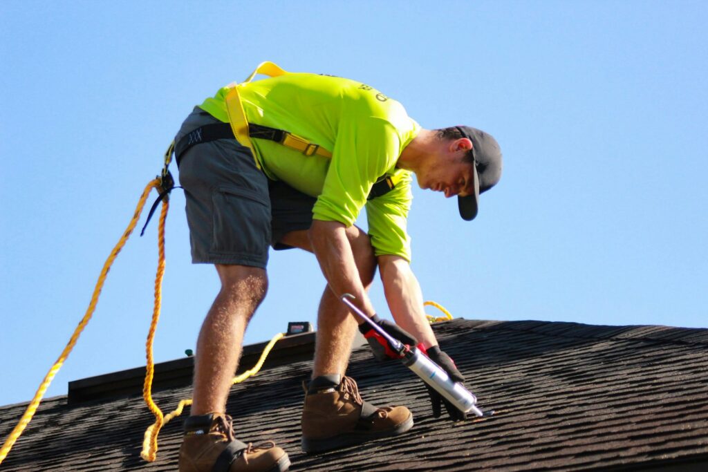 Roofer repairing a shingle roof