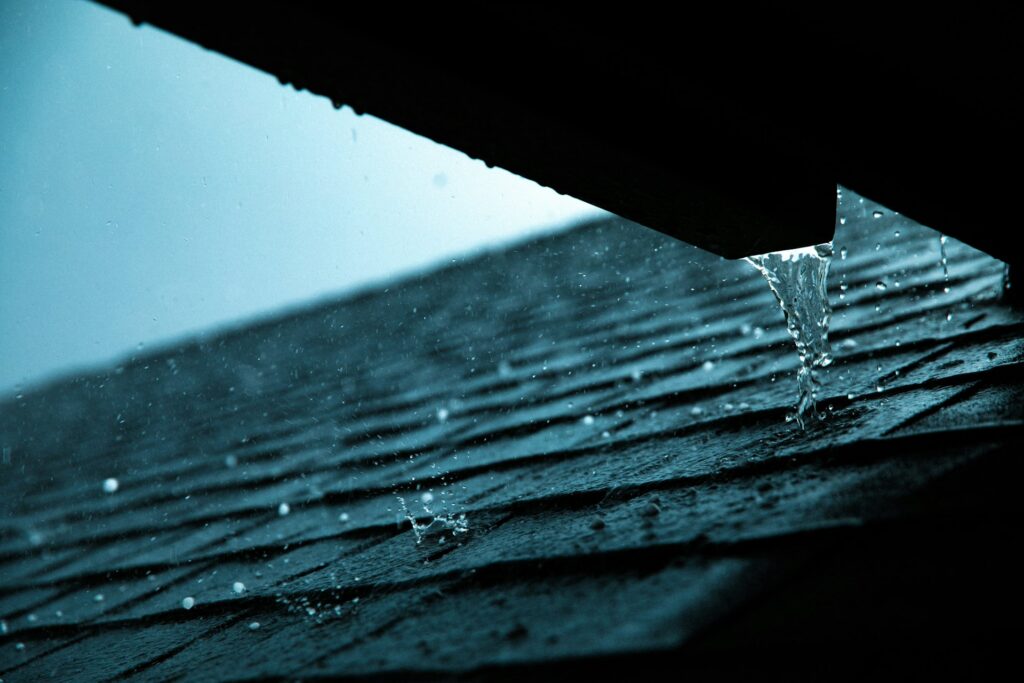 Rain running off a shingle roof edge